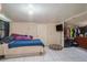 Simple bedroom featuring tile floors, tv, and closet space at 5651 6Th St, Zephyrhills, FL 33542