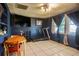 Room with large windows, a treadmill, ceiling fan and table and chairs at 5651 6Th St, Zephyrhills, FL 33542