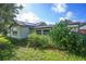 Exterior view of a home with lush greenery and well-maintained lawn at 5651 6Th St, Zephyrhills, FL 33542