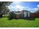 Exterior of a home with a fenced yard and various plants and greenery at 5651 6Th St, Zephyrhills, FL 33542