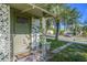 Close-up of the front porch with a small bench and decorative porch columns at 5651 6Th St, Zephyrhills, FL 33542