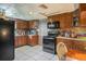 Traditional kitchen featuring wood cabinets, modern appliances, and tile floors at 5651 6Th St, Zephyrhills, FL 33542