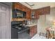 Kitchen featuring wood cabinets, modern appliances, and a countertop area at 5651 6Th St, Zephyrhills, FL 33542