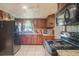 Functional kitchen featuring wood cabinets, modern appliances, and tile floors at 5651 6Th St, Zephyrhills, FL 33542