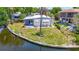 An aerial view of the property showcases its waterfront location, outdoor seating, and well-kept yard at 5806 Portsmouth Dr, Tampa, FL 33615