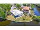 Waterfront property with boat dock, lush landscaping, and screened-in patio offers serene coastal living at 5806 Portsmouth Dr, Tampa, FL 33615