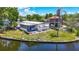 Aerial view displays the property's waterfront location, screened porch, and lawn at 5806 Portsmouth Dr, Tampa, FL 33615