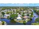 Aerial view highlighting the waterfront community with lush landscaping and canal access at 5806 Portsmouth Dr, Tampa, FL 33615