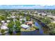 Stunning aerial view showcasing waterfront homes along a serene canal under a beautiful blue sky at 5806 Portsmouth Dr, Tampa, FL 33615
