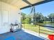 View of the back porch, complete with a utility sink and serene waterfront views and a palm tree at 5806 Portsmouth Dr, Tampa, FL 33615