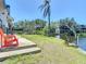 The backyard features a grassy yard leading to the waterfront with a seating area at 5806 Portsmouth Dr, Tampa, FL 33615