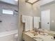 Well-lit bathroom features a marble-top vanity and tiled shower/bathtub combination at 5806 Portsmouth Dr, Tampa, FL 33615