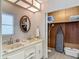 Bathroom boasting dual sinks, a lighted vanity, wood floors and a utility closet at 5806 Portsmouth Dr, Tampa, FL 33615
