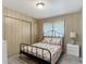 Comfortable bedroom with a cozy bed, closet space, and natural light from the window at 5806 Portsmouth Dr, Tampa, FL 33615