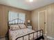 Comfortable bedroom with a cozy bed, closet space, and natural light from the window at 5806 Portsmouth Dr, Tampa, FL 33615
