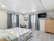 Spacious bedroom featuring wood floors, a large window, and updated blinds and curtains at 5806 Portsmouth Dr, Tampa, FL 33615