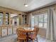 Cozy dining area featuring natural light, laminate flooring, and built-in cabinets at 5806 Portsmouth Dr, Tampa, FL 33615