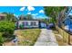 Charming one-story home featuring a long driveway, boat on the side, and well-maintained lawn at 5806 Portsmouth Dr, Tampa, FL 33615