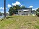 Exterior view of the home with a well-maintained lawn and waterfront access at 5806 Portsmouth Dr, Tampa, FL 33615