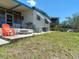 Exterior showcasing the home's covered porch, waterfront access, and yard at 5806 Portsmouth Dr, Tampa, FL 33615