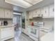 Cozy kitchen featuring classic white cabinets, modern appliances, and a breakfast bar at 5806 Portsmouth Dr, Tampa, FL 33615
