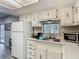 The kitchen features a window over the sink and ample cabinet storage at 5806 Portsmouth Dr, Tampa, FL 33615