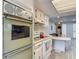 Cozy kitchen featuring classic white cabinets, modern appliances, and a breakfast bar at 5806 Portsmouth Dr, Tampa, FL 33615
