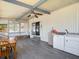 Sunroom features ceiling fan, wood floors, screened windows, and full size laundry setup at 5806 Portsmouth Dr, Tampa, FL 33615