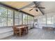 Sunroom showcases wood style floors, multiple windows, and a lovely ceiling fan at 5806 Portsmouth Dr, Tampa, FL 33615