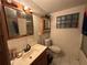 An old bathroom with a vintage sink, toilet, and tiled walls at 5853 39Th St N, St Petersburg, FL 33714