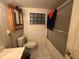 Tiled bathroom featuring a toilet, shower with sliding glass door, vanity and medicine cabinet at 5853 39Th St N, St Petersburg, FL 33714