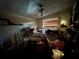 Bedroom with a ceiling fan and a window, piled with furniture and boxes at 5853 39Th St N, St Petersburg, FL 33714