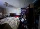 Bedroom featuring a bed with an unmade comforter, ceiling fan, and wallpaper at 5853 39Th St N, St Petersburg, FL 33714