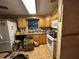 Retro kitchen featuring vintage appliances and wood cabinetry with cluttered countertops at 5853 39Th St N, St Petersburg, FL 33714