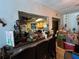 An open space and breakfast bar looking into a cluttered vintage kitchen with oak cabinets at 5853 39Th St N, St Petersburg, FL 33714