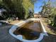 Backyard features an empty in-ground pool surrounded by mature trees at 5853 39Th St N, St Petersburg, FL 33714