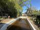 Backyard features an empty in-ground pool surrounded by mature trees at 5853 39Th St N, St Petersburg, FL 33714