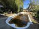 Backyard features an empty in-ground pool surrounded by mature trees at 5853 39Th St N, St Petersburg, FL 33714