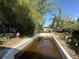 Backyard features an empty in-ground pool surrounded by mature trees at 5853 39Th St N, St Petersburg, FL 33714
