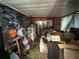 Cluttered storage room with various items, tarps, and a sliding glass door at 5853 39Th St N, St Petersburg, FL 33714