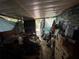 Cluttered storage room with various items, tarps and other coverings at 5853 39Th St N, St Petersburg, FL 33714