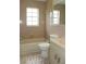 Bathroom featuring tile flooring and walls, vanity, toilet, and bathtub with shower at 6144 Elmhurst Dr, New Port Richey, FL 34653