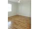 Minimalist bedroom with hardwood floors, one window, and neutral wall paint at 6144 Elmhurst Dr, New Port Richey, FL 34653