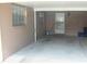Covered carport with a neutral wall and entryway door at 6144 Elmhurst Dr, New Port Richey, FL 34653