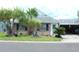 Charming single-story home with mature landscaping, including palm trees, and a covered carport at 6144 Elmhurst Dr, New Port Richey, FL 34653