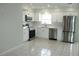Modern kitchen featuring stainless steel appliances and white cabinetry and backsplash at 6144 Elmhurst Dr, New Port Richey, FL 34653