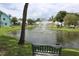 Picturesque pond view featuring fountain and lush greenery, creating a tranquil setting at 6144 Elmhurst Dr, New Port Richey, FL 34653
