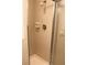 Shower stall with tile walls, shower head, soap dish, and glass door at 6144 Elmhurst Dr, New Port Richey, FL 34653