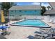 Sparkling swimming pool surrounded by lounge chairs and tables, perfect for relaxation at 6144 Elmhurst Dr, New Port Richey, FL 34653