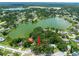 Beautiful aerial view showcasing a home nestled among lush trees near a serene lake, highlighting a peaceful setting at 616 Pawn Way, Seffner, FL 33584
